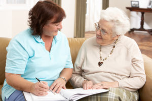 Caregiver discussing care plans with senior woman