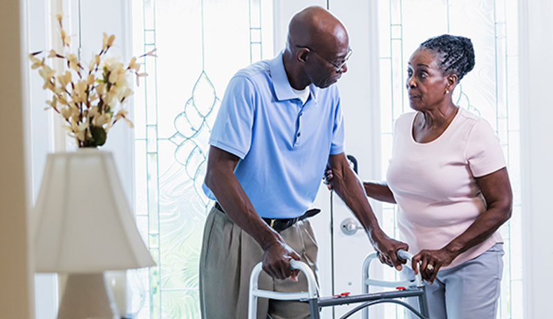 caregiver-assisting-senior-with-Parkinsons