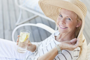 Happy senior woman enjoying lemon water