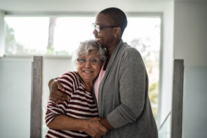 A woman embraces her aging mother after using tips for anxiety management in older loved ones.